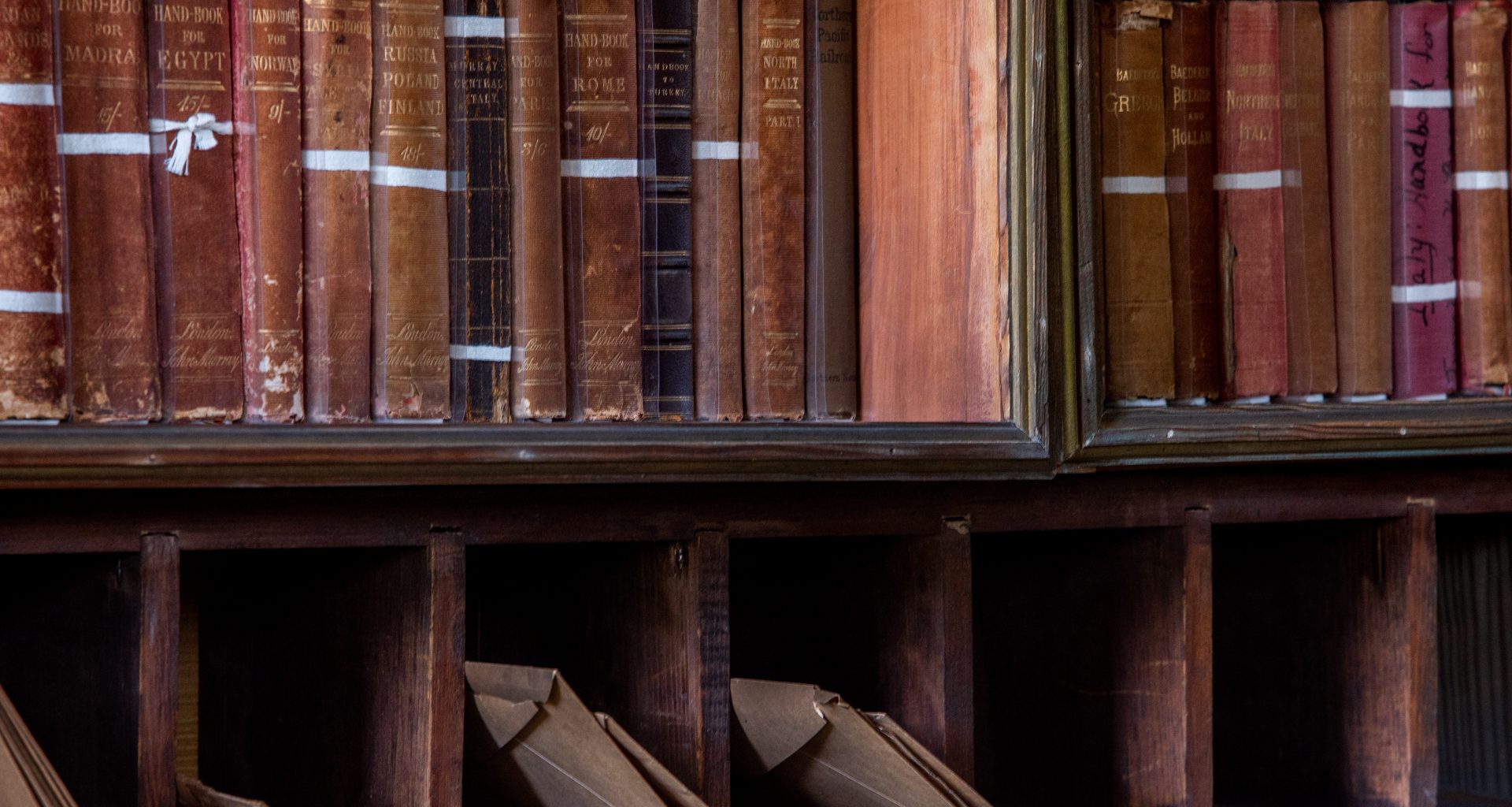 Antique desk with books and letters in pigeonholes