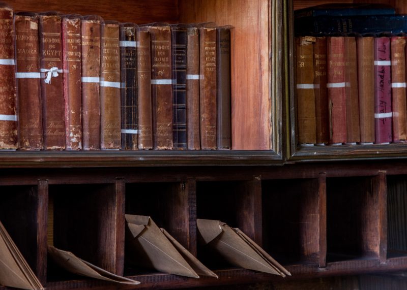 Antique desk with books and letters in pigeonholes