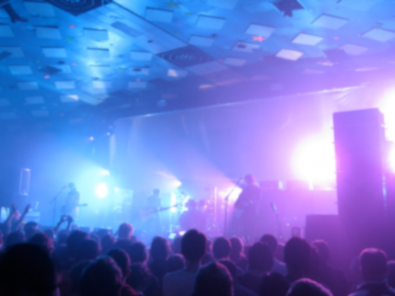 Photo of My Bloody Valentine on stage with purple lighting and fog machines