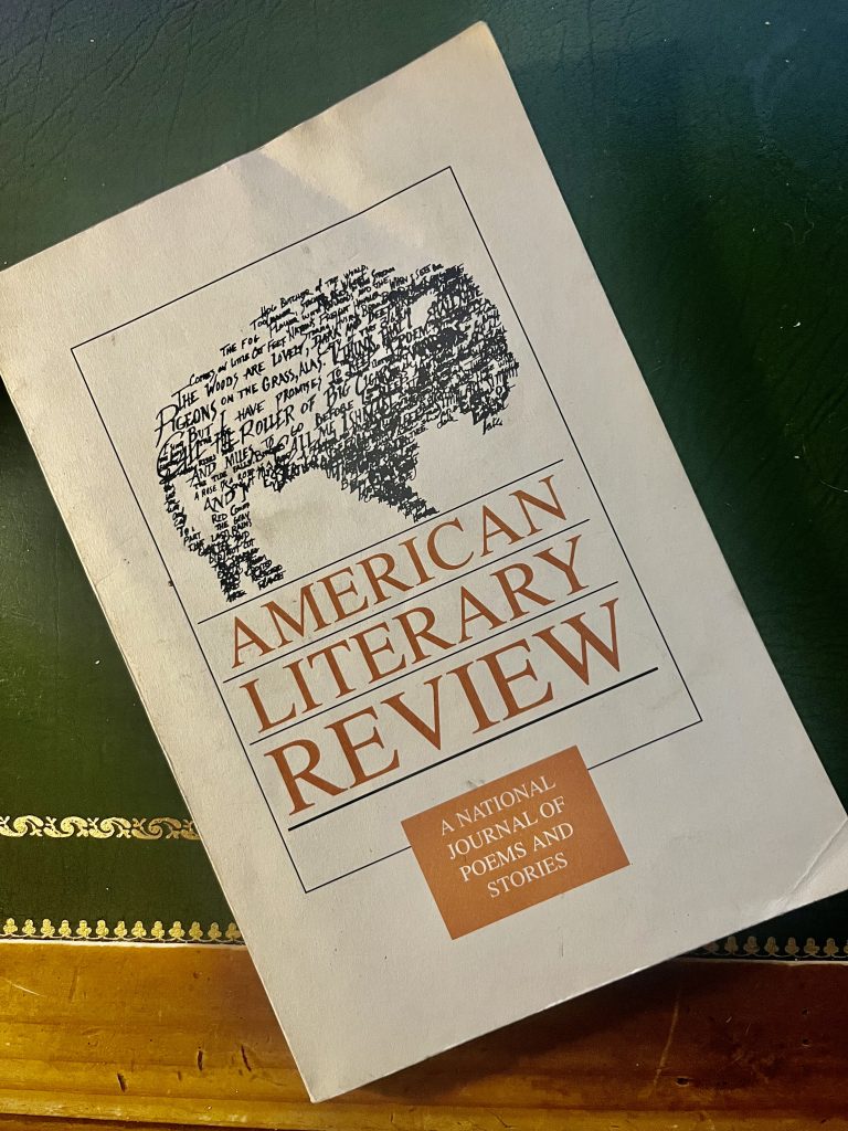 A book on a table, titled "American Literary Review: A National Journal of Poems and Stories"
