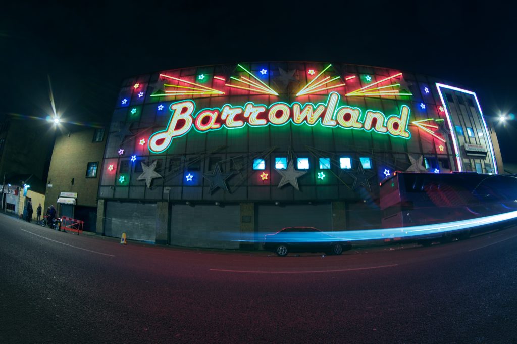 Photo of the Barrowland Ballroom at night with brightly-lit multi-colored sign